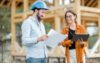 Contractor and architect working together outside of construction site - apartment internet